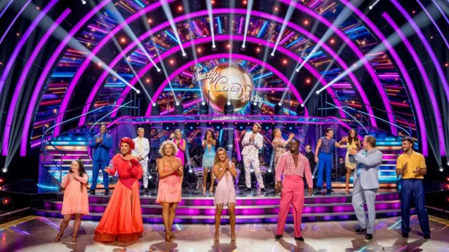 The celebrities stood on the Strictly stage clapping