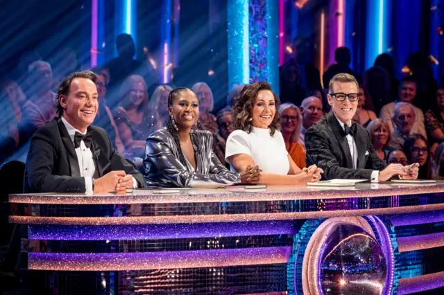 Craig Revel Horwood, Motsi Mabuse, Shirley Ballas & Anton Du Beke sitting on their judging panel with audience behind them