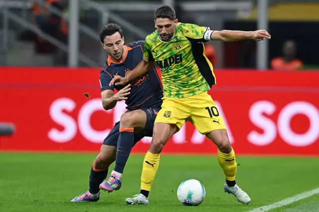 Berardi and Augusto battle for the ball