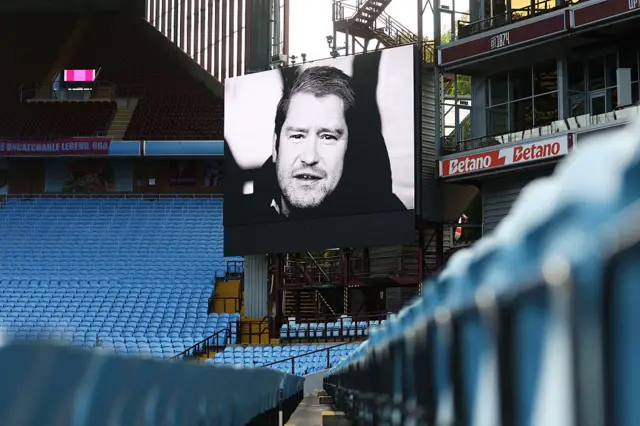 A black and white picture of Matt Beard is shown on a screen at Villa Park