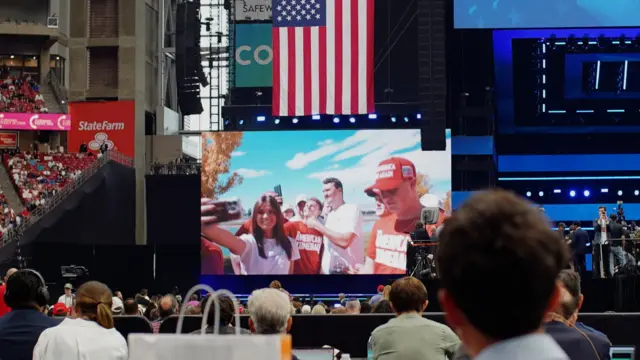 The stadium screens shows a video from Charlie Kirk’s event