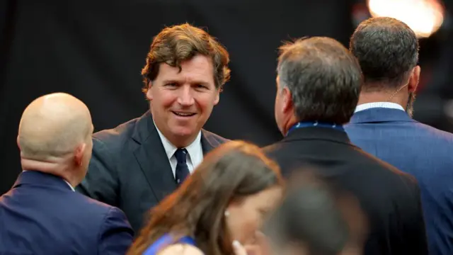 Political commentator Tucker Carlson arrives at the memorial service