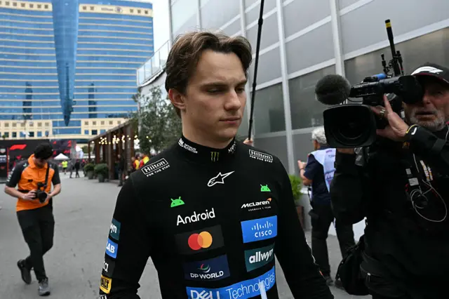 Oscar Piastri walks back to the paddock after crashing out