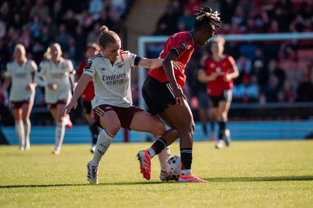Kim Little and Melvine Malard battle for possession