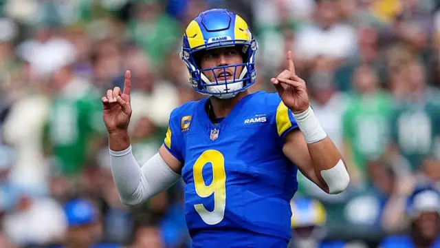 Matt Stafford points to the sky while playing for the Los Angeles Rams against the Philadelphia Eagles