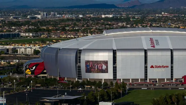 A Charlie Kirk memorial banner has been put up on the side of the State Farm Stadium