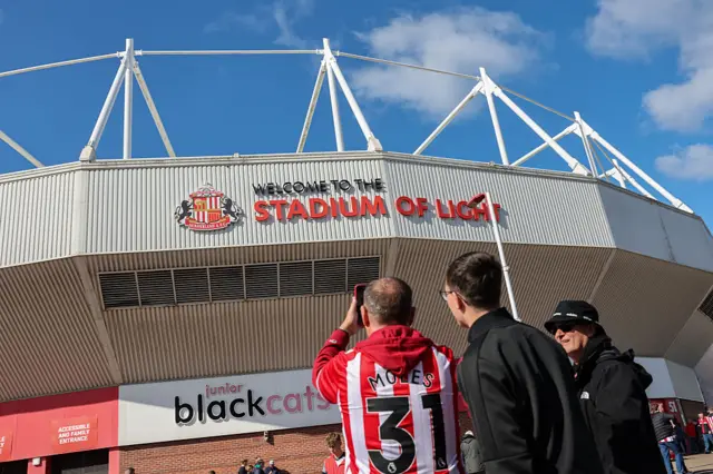 Fan takes a picture of the stadium of light