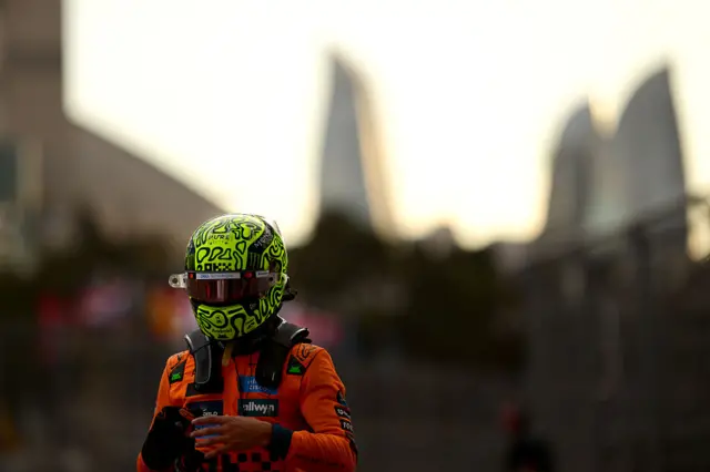 Lando Norris walks away with his race helmet on after qualifying in seventh in Baku