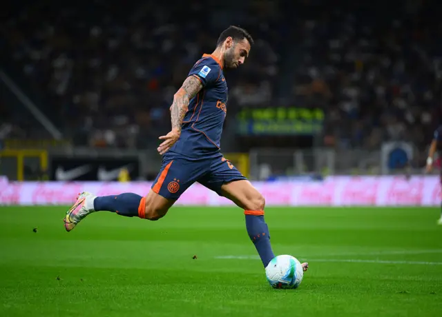 Calhanoglu  shapes to cross the ball