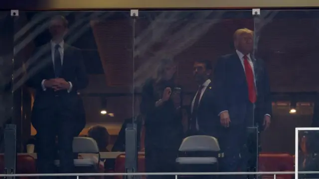 Trump watching on from behind glass