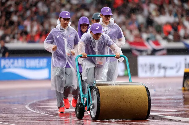 Ground staff trying to collect rain