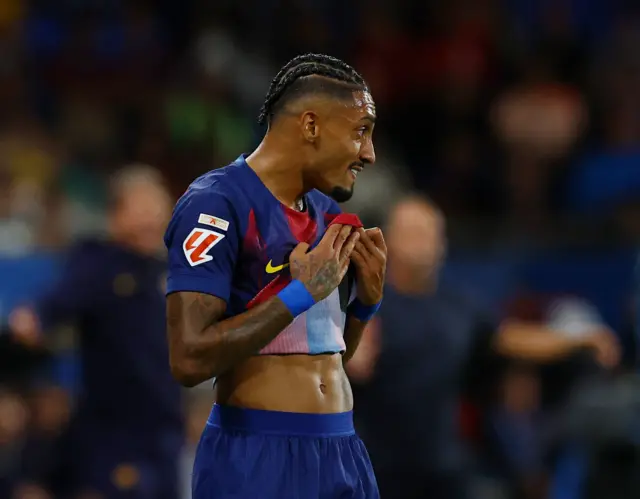 Raphinha wipes his face with his shirt