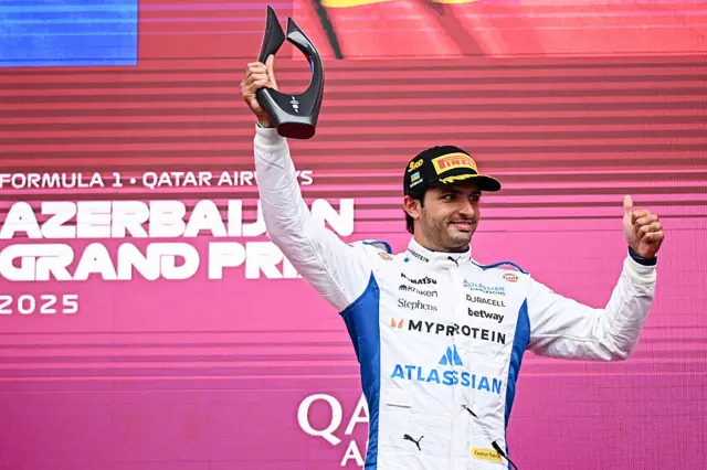 Carlos Sainz celebrates on the podium