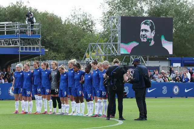 Chelsea players stand for a moment of silence for Matt Beard