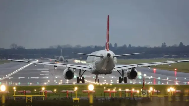 The tail of a jumbo jet as it taxis towards the runway ready to take off.