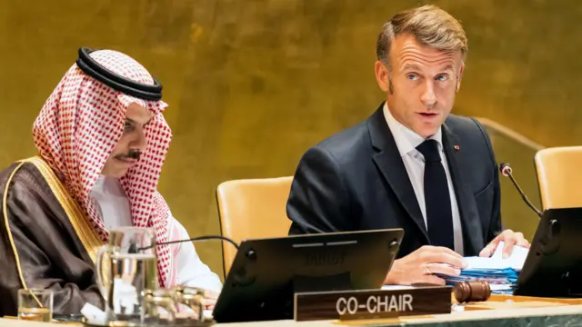 Emmanuel Macron sits next to Saudia Arabian foreign minister