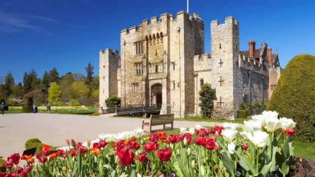 Exterior shot of Hever Castle with lots of flowers in foreground