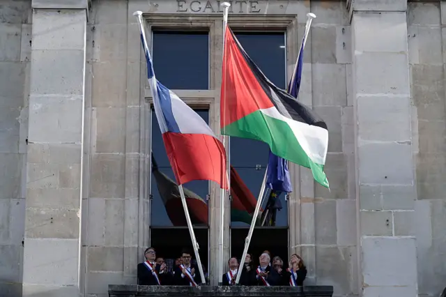 French socialist party first secretary Olivier Faure (L) attends a flag raising ceremony of the Palestinian flag outside Saint-Denis town hall, near Paris, on September 22, 2025. France's interior ministry has ordered prefects to oppose the display of Palestinian flags on town halls and other public buildings. The warning from the interior ministry came after Socialist leader Olivier Faure called for the Palestinian flag to be flown on town halls on September 22, 2025