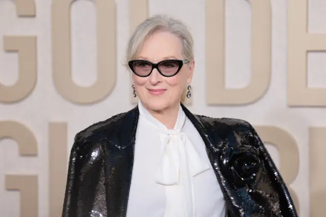 Meryl Streep arrives for the 81st annual Golden Globe Awards ceremony in Beverly Hills, California, on 07 January 2024. She is smiling, wearing a glittering black jacket and shades.