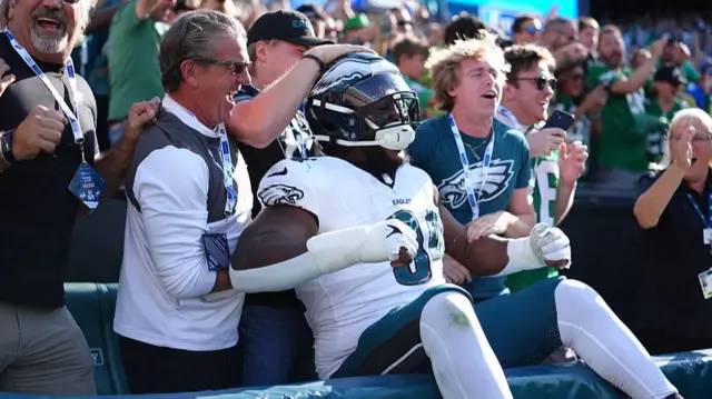 Philadelphia Eagles defensive lineman Byron Young celebrates with the team's fans