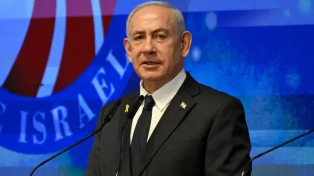 Benjamin Netanyahu speaking from behind a podium on stage