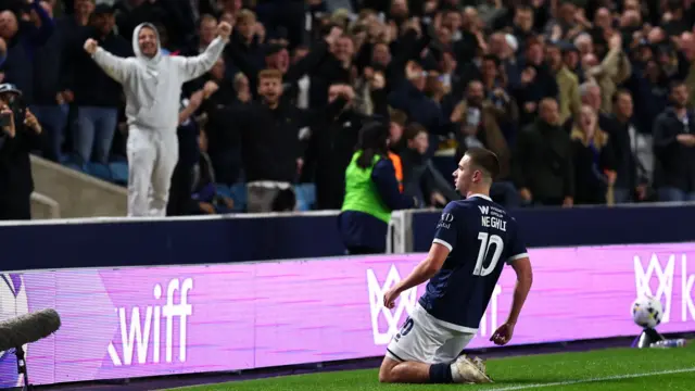 Camiel Neghli slides on his knees to celebrate scoring against Watford