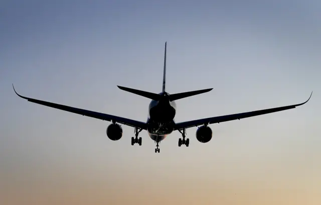 Silhouette of a plane landing at Gatwick