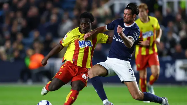 Nestory Irankunda of Watford with a shot on goal blocked by Tristan Crama of Millwall