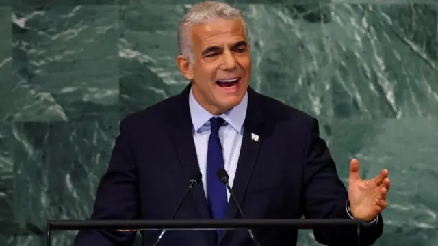 Yair Lapid  speaking at a podium