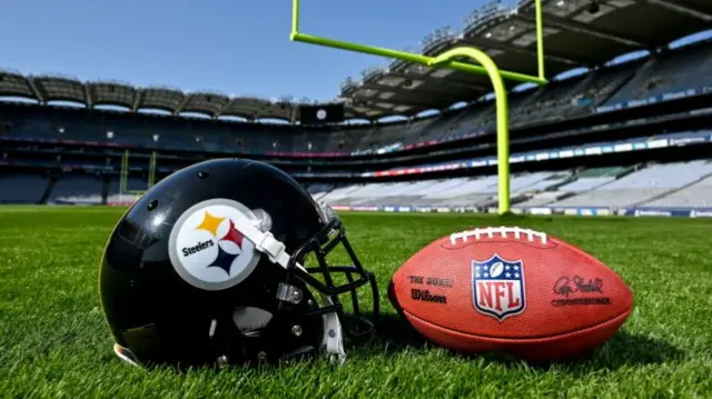 A Pittsburgh Steelers helmet and NFL ball on the field at Croke Park
