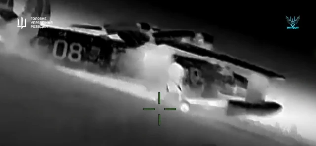 A black and white image taken from the video showing one of the aircraft in the drone's targeting sight