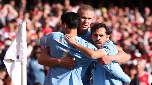 Erling Haaland celebrates with Bernardo Silva and Tijjani Reijnders