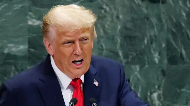 Close up of Donald Trump addressing the UN General Assembly in a dark blue suit and red tie