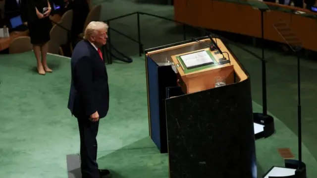Trump standing behind lectern