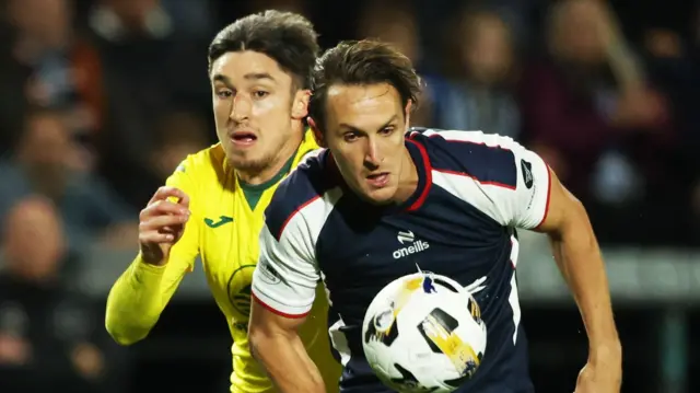 Hibs Kieron Bowie chases Falkirk's Liam Henderson