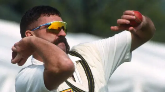 Merv Hughes with signature moustache bowling during a cricket match