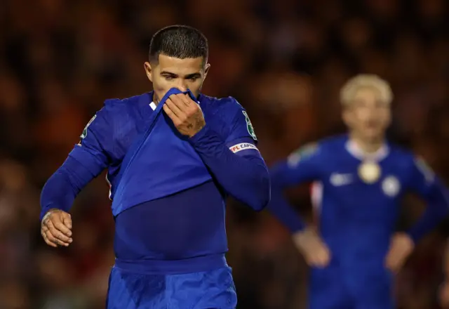 Fernandez wipes his face with his shirt