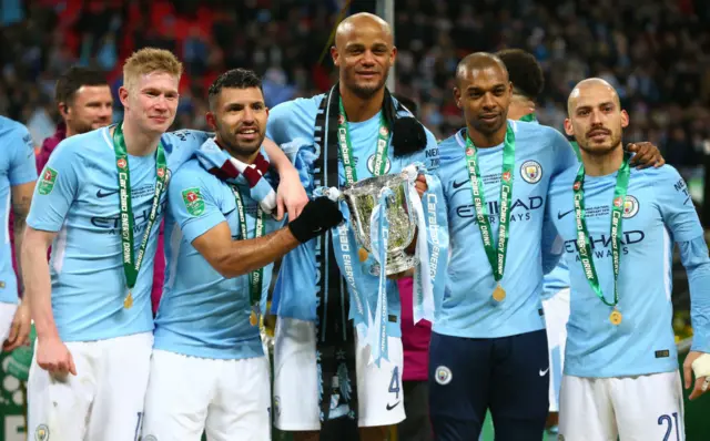 Vincent Kompany and his Manchester City team-mates with the League Cup trophy in 2018