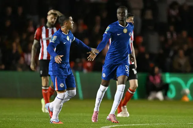 George and Fernandez low five to celebrate the equaliser