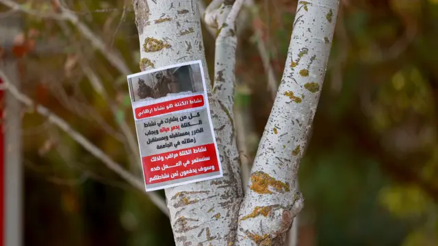 A poster left by Israeli forces reads “Bloc activity is terrorist activity”, referring to al-Wafa Islamic bloc, a student group linked to Hamas