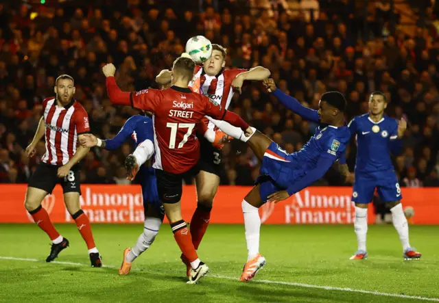 Lincoln and Chelsea players battle for the ball