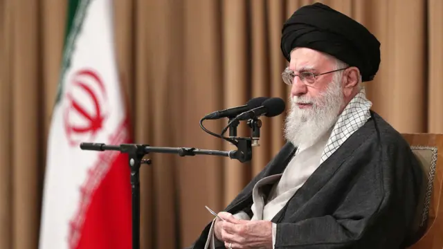 Iranian supreme leader Ayatollah Ali Khameni speaking into a microphone