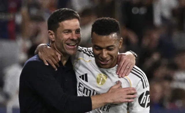 Xabi Alonso and Kylian Mbappe embrace