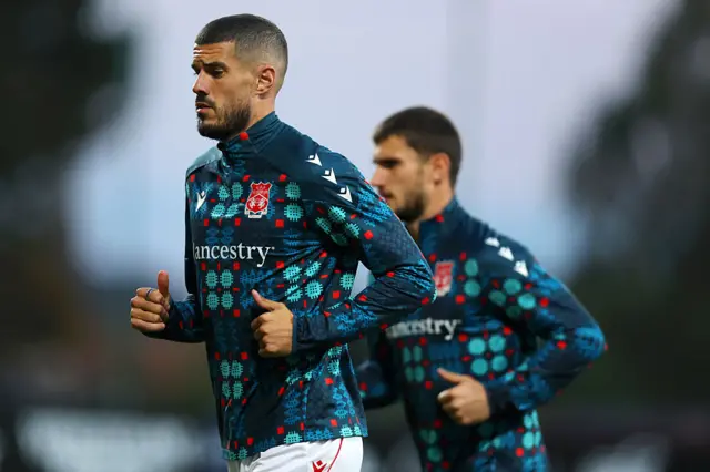 Conor Coady warms up for Wrexham
