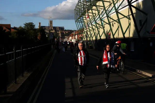 Fans arrive at a sunsoaked Sincil Bank