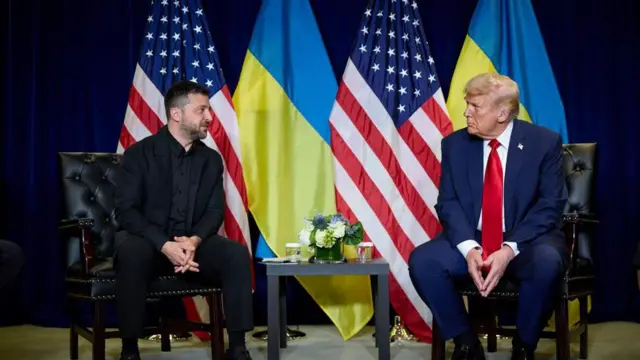 Zelensky and Trump sit together at the UN, with US and Ukrainian flags behind them