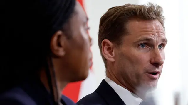 Britain's main opposition Conservative Party leader Kemi Badenoch (L) listens as Britain's main opposition Conservative Party Shadow Home Secretary Chris Philp speaks during a press conference to talk about grooming gangs, in central London on June 17, 2025