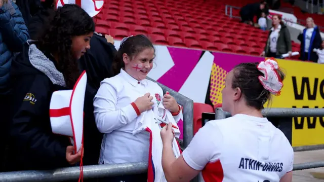 Lark Atkin-Davies talks to a young England fan after the quarter-final win over Scotland