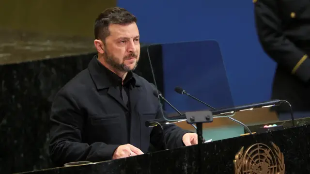 Ukraine's President Volodymyr Zelensky speaks into a microphone at the UN General Assembly meeting