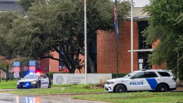 two police cars outside the front of the Dallas ICE Field Office